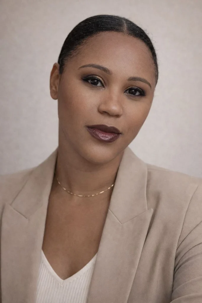 portrait of Arielle Davis wearing a tan jacket and white blouse